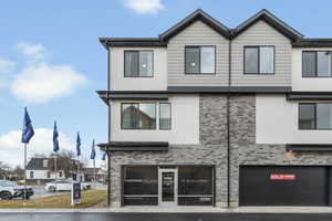View of front of house with brick siding and stucco siding