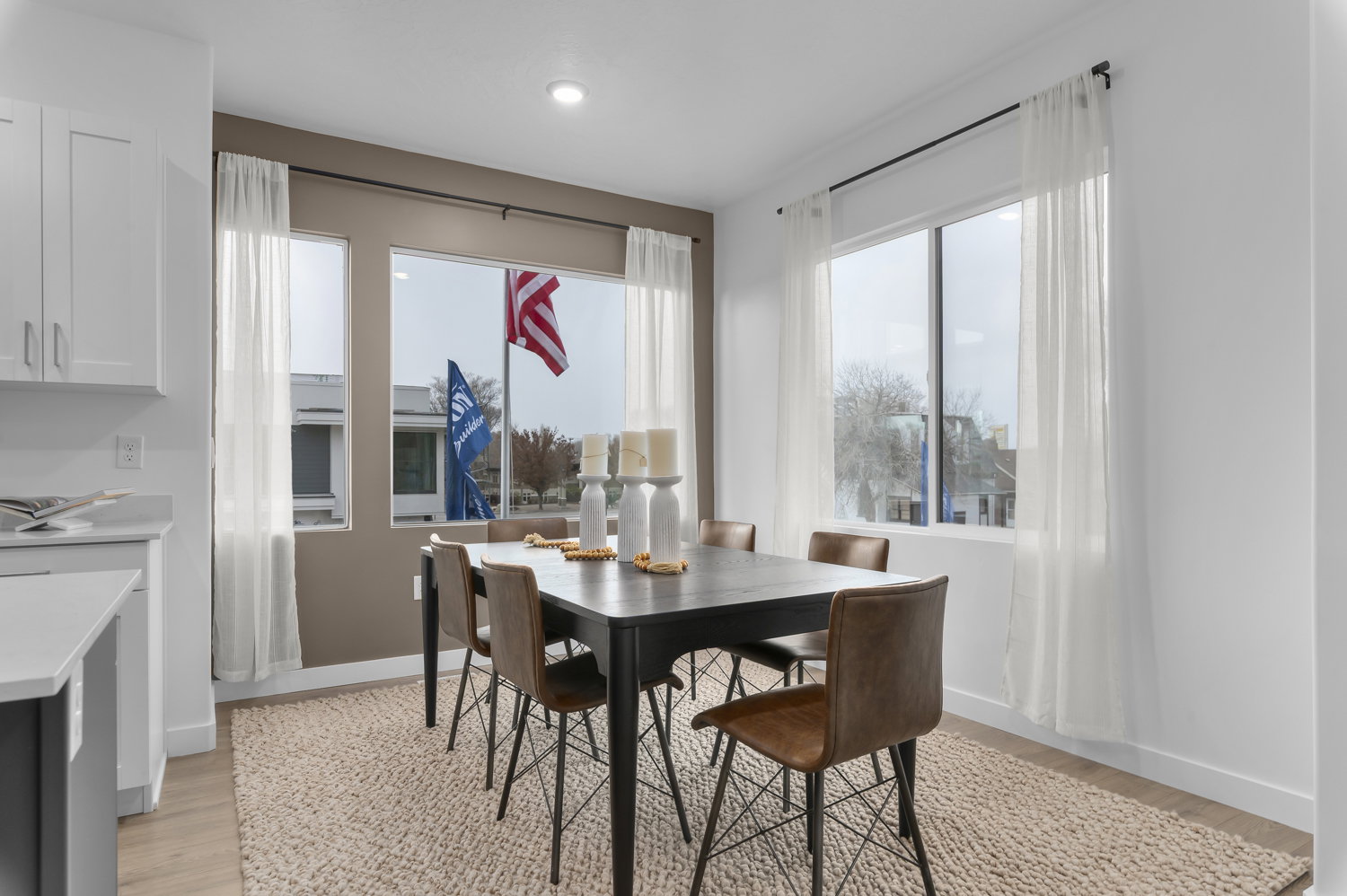 Dining room with light wood-type flooring and recessed lighting
