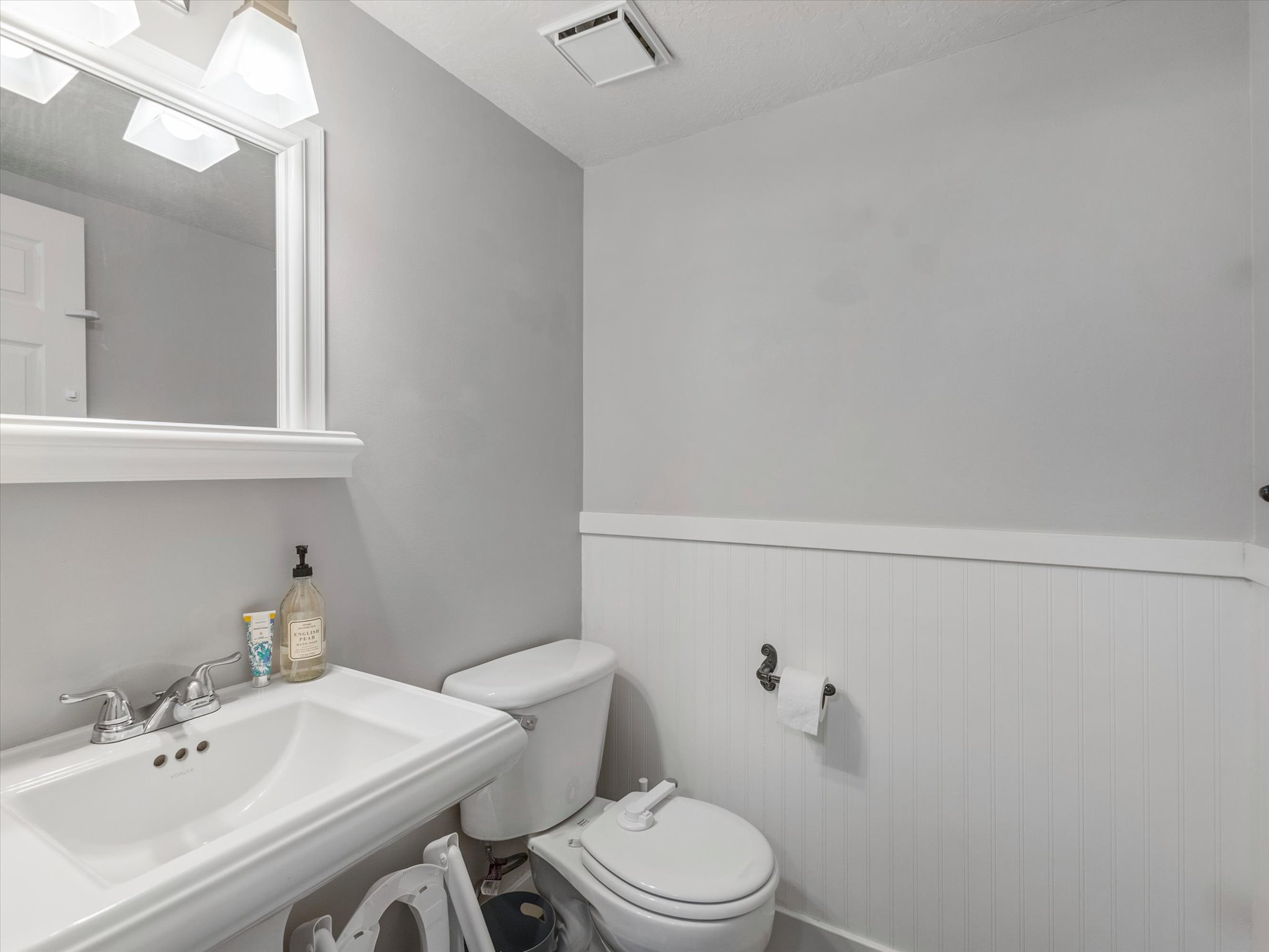 Bathroom with toilet and wainscoting