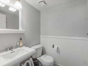 Bathroom with toilet and wainscoting