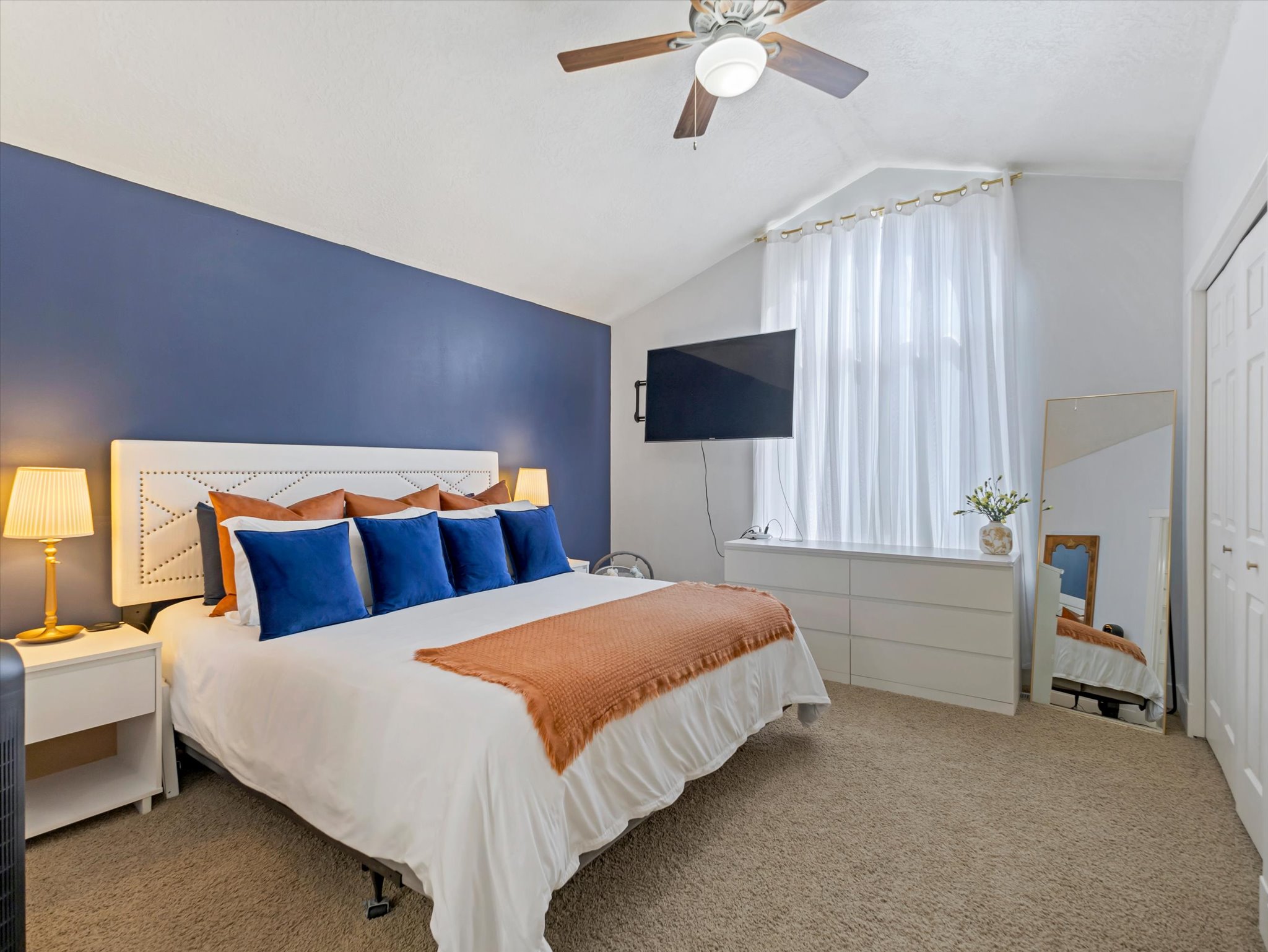 Carpeted bedroom with a closet and ceiling fan