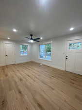 Unfurnished living room featuring light wood finished floors, a ceiling fan, recessed lighting, and healthy amount of natural light