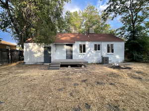 Rear view of house featuring a wooden deck and brick siding