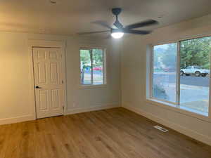Unfurnished bedroom with light wood-style floors and a ceiling fan