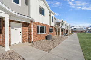 View of side of property with brick siding, a residential view, and board and batten siding