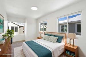 Carpeted bedroom featuring baseboards