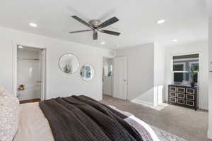 Large primary Bedroom featuring light carpet, a ceiling fan, recessed lighting, and ensuite bath