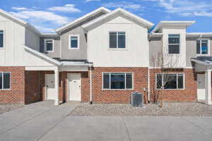 View of front of property with brick siding and board and batten siding