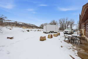 Yard covered in snow with outdoor dining space