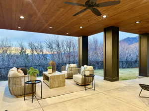 Fenced backyard with a ceiling fan and an outdoor living space