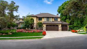 View of front of home with a front lawn, stone siding, stucco siding, and a chimney