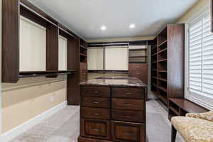 Walk in closet with light carpet