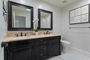 Full bath featuring double vanity and a shower with curtain