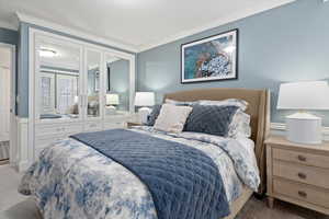 Bedroom featuring crown molding and carpet flooring