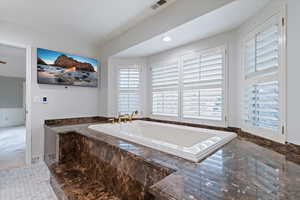 Bathroom featuring a bath and recessed lighting