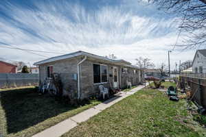 View of side of home featuring a fenced backyard
