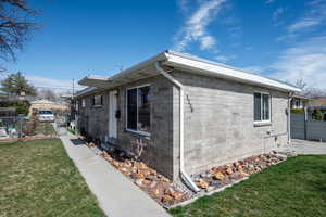 View of home's exterior featuring concrete block siding