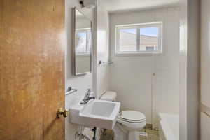 Bathroom featuring toilet and shower / tub combination