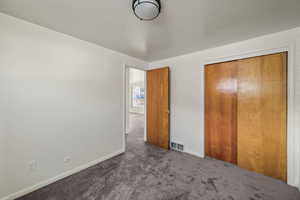 Unfurnished bedroom featuring carpet floors and a closet