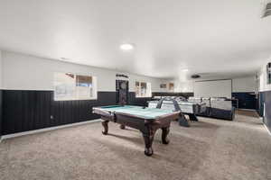 Game room featuring a wainscoted wall, wooden walls, carpet floors, and billiards table