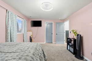 Bedroom featuring baseboards and light colored carpet