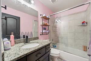 Full bathroom with vanity and shower / bath combination with glass door