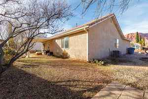 View of property exterior featuring a patio area, stucco siding, and a mountain view