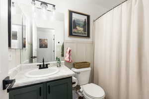 Full bathroom with vanity and a shower with shower curtain