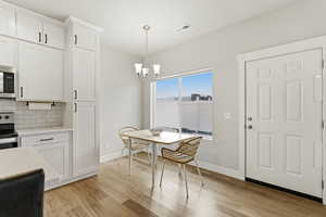 Dining area featuring a chandelier and  wood-style floors