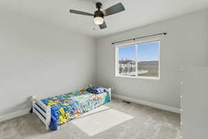 Large bedroom with a ceiling fan