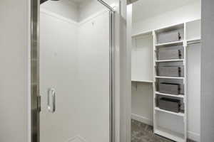 Primary walk in closet and stall shower