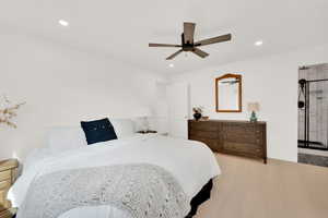 Bedroom with engineered hardwood flooring, a ceiling fan, and recessed lighting
