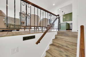 Stairs featuring upgraded railing, recessed lighting, and crown molding