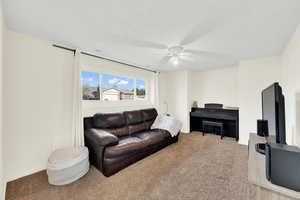 Basement family room featuring carpet and ceiling fan