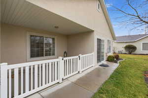 Covered patio and sidewalk out the living room sliding door