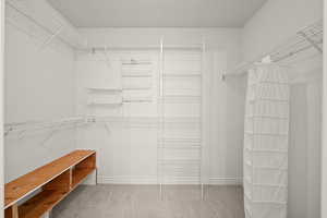 Primary bedroom walk in closet