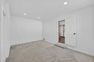 Unfurnished room featuring light colored carpet, recessed lighting, and a textured ceiling