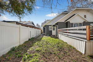 View of side of property featuring brick siding and a cooling unit