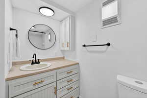 Bathroom featuring vanity and toilet