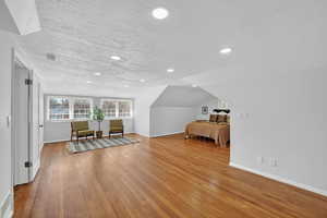 Bedroom with light wood-style floors and recessed lighting