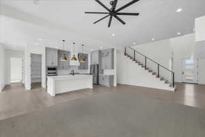 Unfurnished living room featuring ceiling fan, light wood-style flooring, and recessed lighting