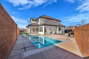Back of house featuring a patio area, a fenced backyard, and stucco siding