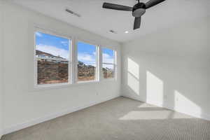 Empty room with a ceiling fan, light carpet, and recessed lighting
