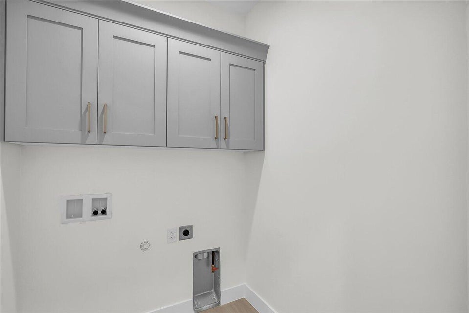 Laundry area featuring hookup for a gas dryer, washer hookup, cabinet space, hookup for an electric dryer, and light wood-style floors