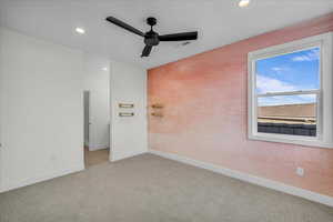 Spare room with ceiling fan, light colored carpet, and recessed lighting