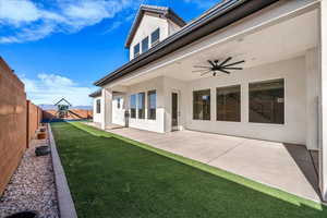 Rear view of property with a patio, a ceiling fan, stucco siding, and a fenced backyard