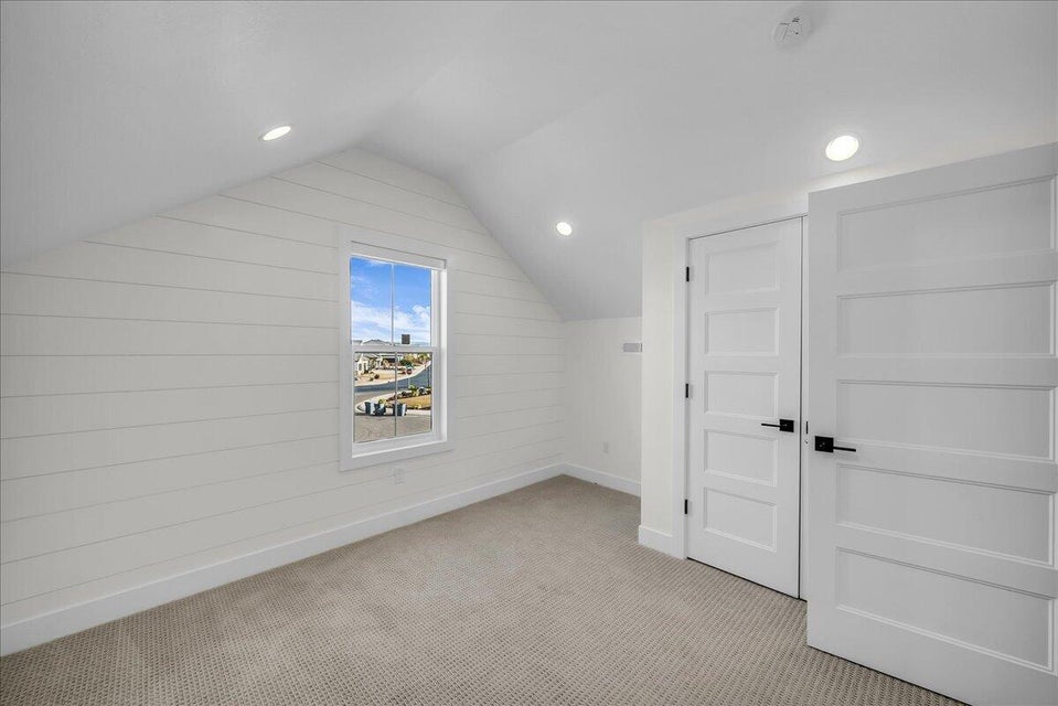 Additional living space with recessed lighting and light carpet