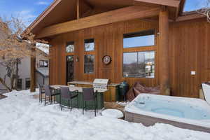 Snow covered patio featuring a patio area