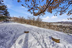 Yard layered in snow featuring a mountain view