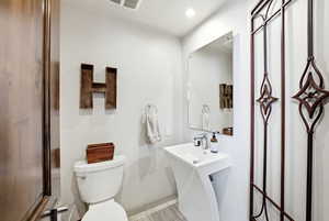 Bathroom with toilet and recessed lighting